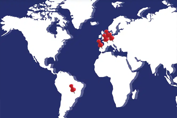 Blue and white world map with red pin points