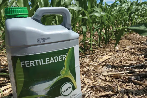 Close up of a fertilizer jug in a field